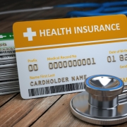 health-care-medical-insurance-card-stethoscope-as-symbol-medicine-wood-background